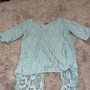 Cute light blue, open back, flowy lace shirt.